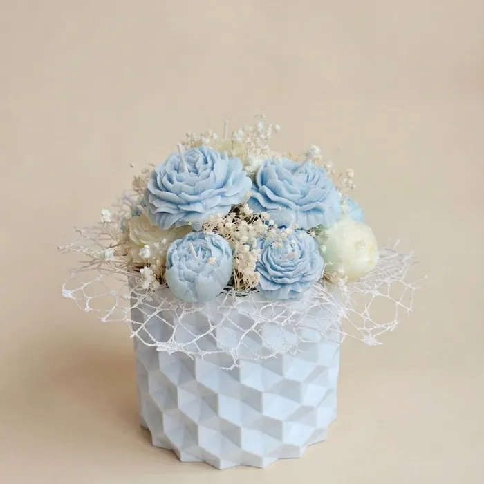 Light blue candle bouquet in an embossed box